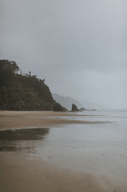 tide washing onto an overcast beach 
