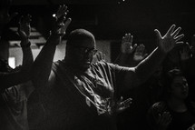 congregation with hands raised praising God 