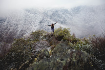 a woman standing on an icy mountaintop 