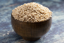 bowl of grains on blue wood background  