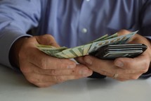 man holding his wallet and counting cash, debt, bills, paying, wealth, businessman