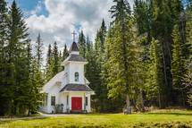 a rural church surrounded by a pine forest 