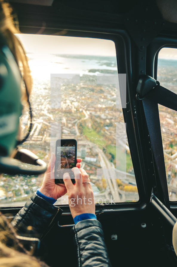 taking a picture out of a helicopter window 
