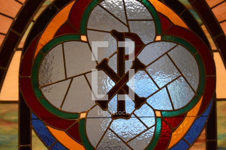 stained glass window of chi and rho ΧΡ for the Greek word ΧΡΙΣΤΟΣ Christ