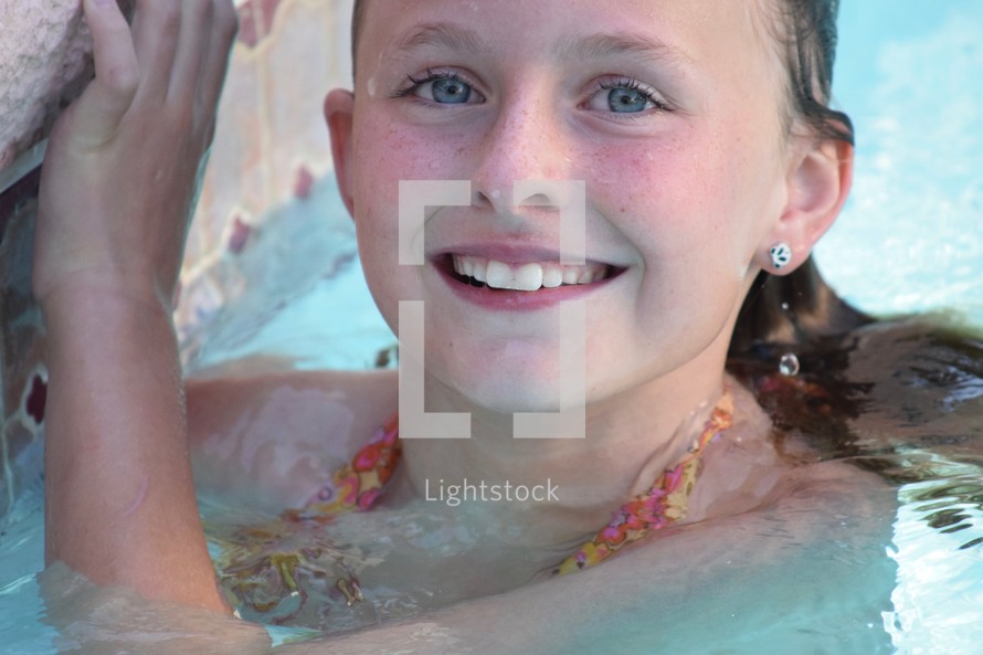 a little girl in a swimming pool 