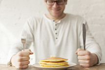 Man eager to eat his pancakes.