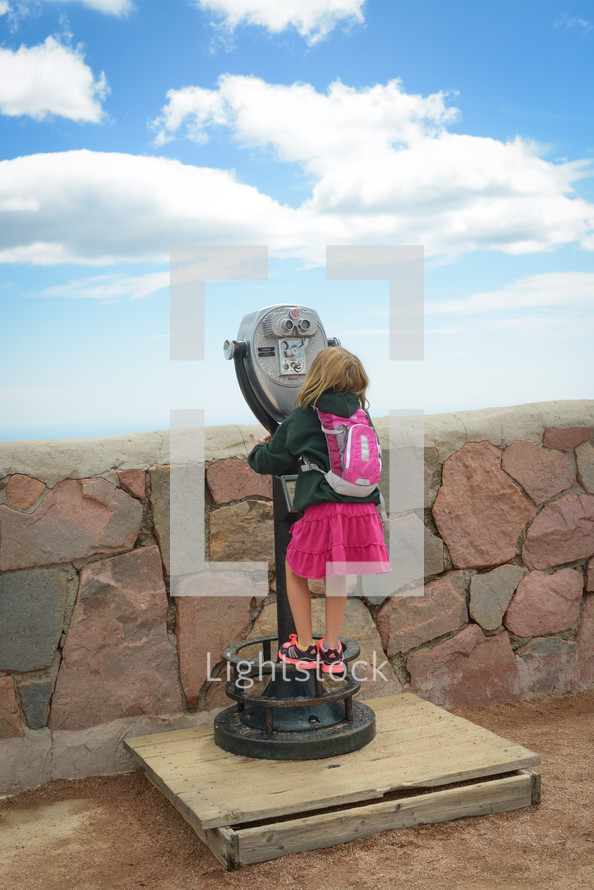 child looking into  view finder 