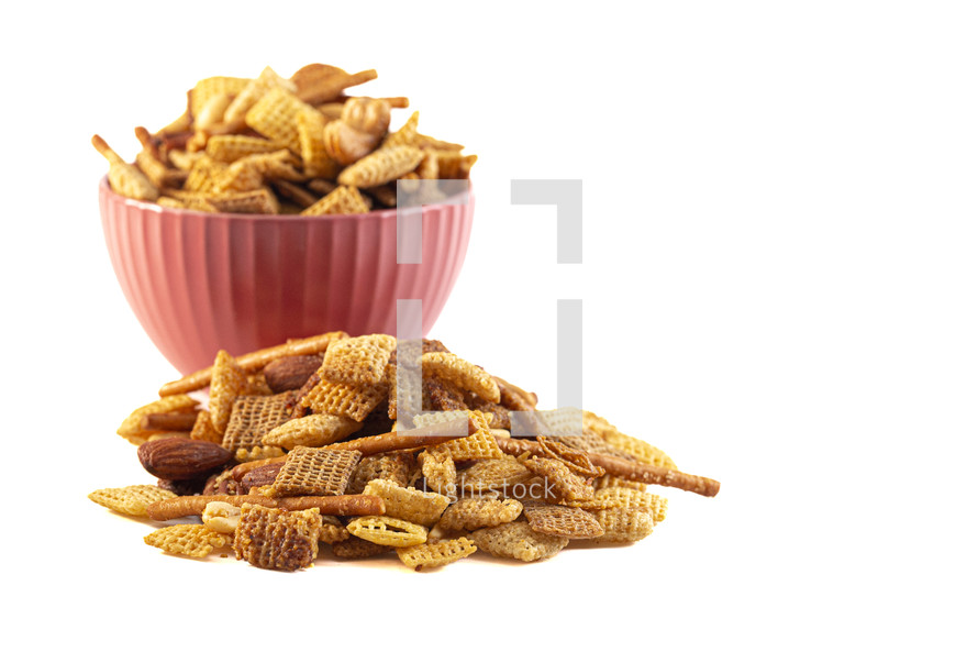 Chex mix in a bowl on a white background