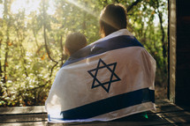 Sisterly Serenity: Embracing Israel's Flag Together