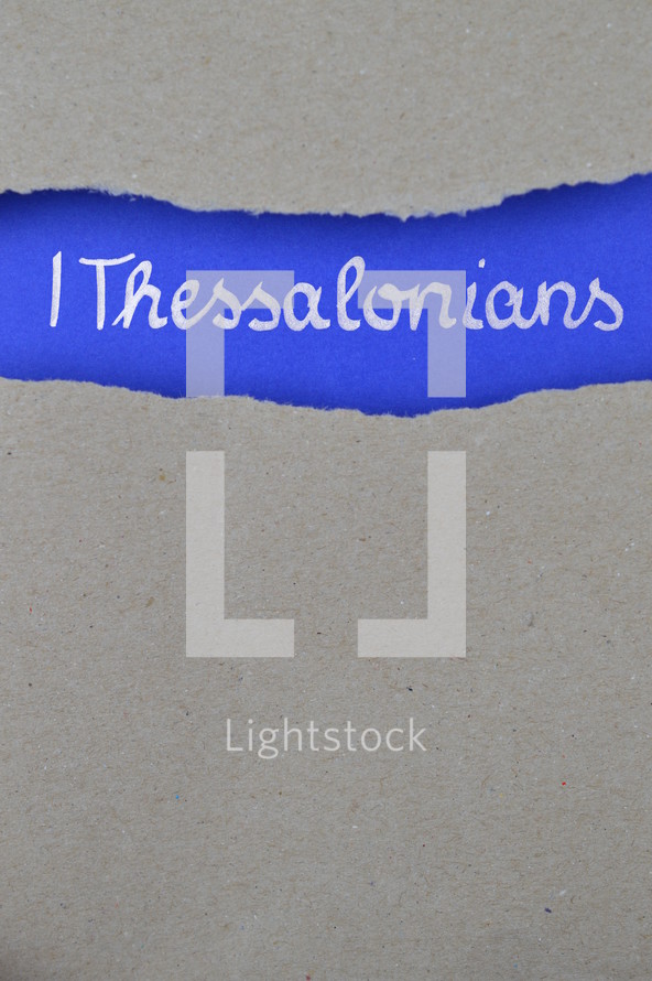 1 Thessalonians - torn open kraft paper over intense blue paper with the name of the first letter from Paul to the Thessalonians