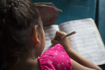 a little girl doing homework 