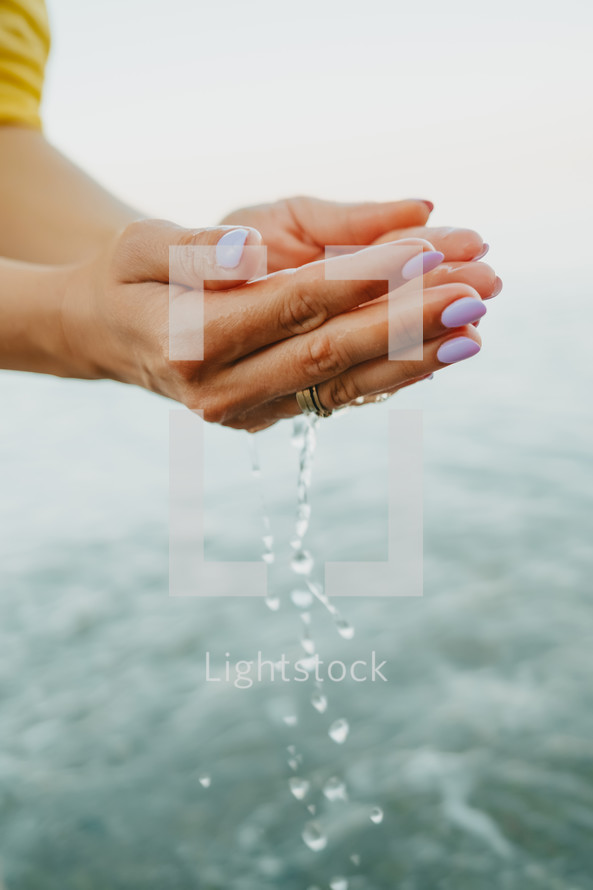 Water pouring from womans hands