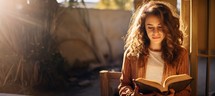 Young woman reading the bible on a sunny day with copy space