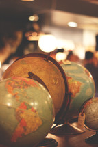 a collection of globes in an antique store 