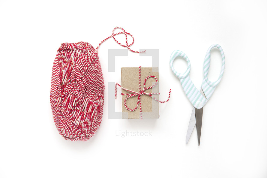 scissors, yarn, and gift box