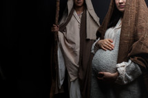 pregnant Mary holding her belly and Joseph 