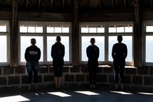 friends looking out a lighthouse windows 