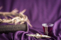 crown of thorns and communion elements on purple 