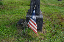 American flag next to a grave 