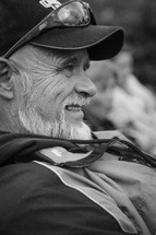 face of an older man with a beard relaxing 