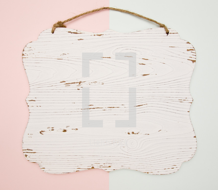 pink and blue background with white wood sign 