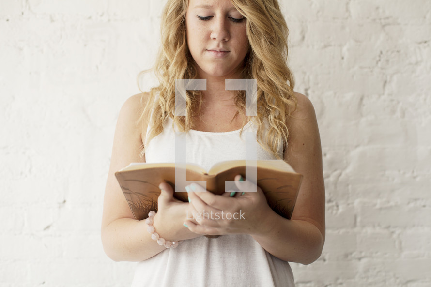 young woman reading a Bible 