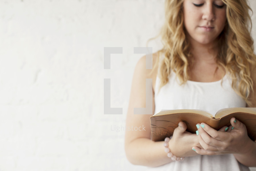 young woman reading a Bible 
