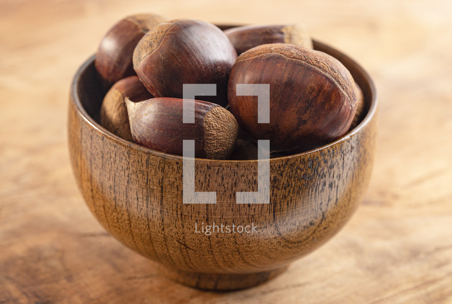 Bowl of hazelnuts on a wood table