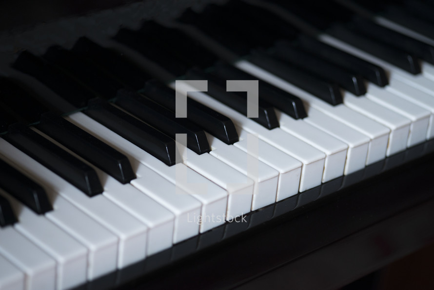 Classic grand piano keyboard close-up, Grand piano keyboard with glossy black and white keys, Musical notes on the piano