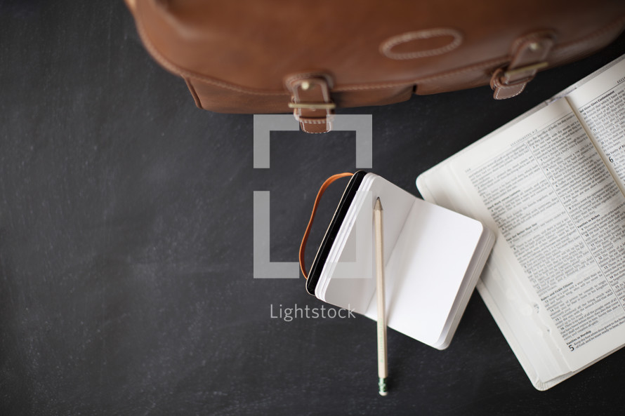 purse, open Bible, journal, pencil 