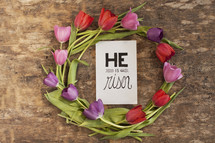 Ring of tulips surrounding a "He is risen" card.