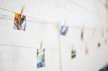 photos hanging in a display on a clothes line