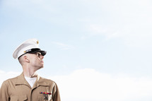 Marine soldier in uniform looking off into the sky.