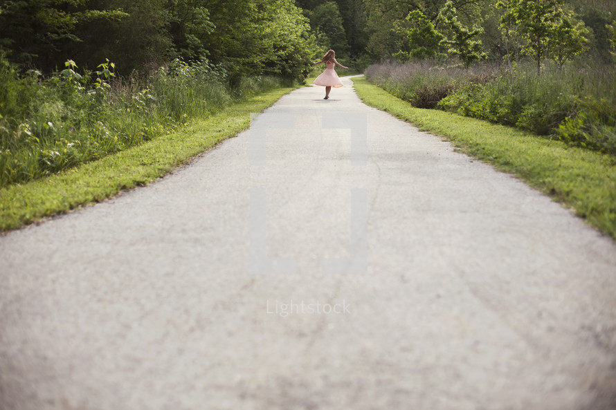 girl running down a paved path