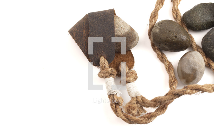 A Sling Shot and Stones Isolated on a White Background from the Story of David and Goliath in the BIble 