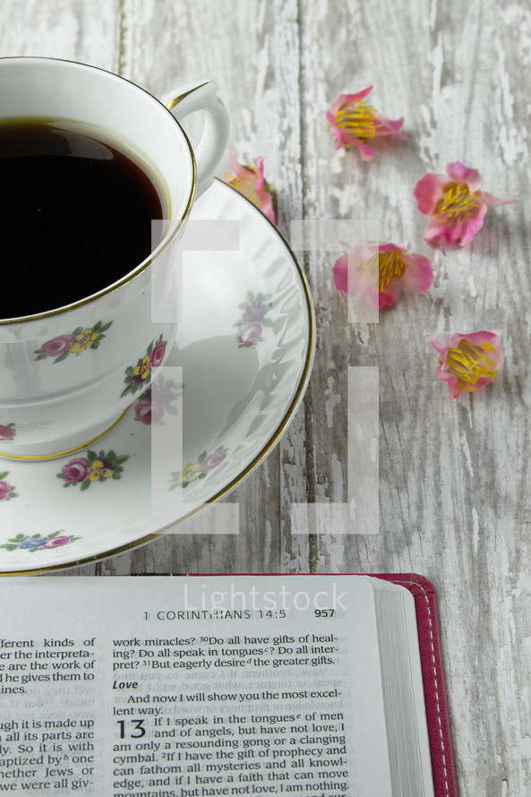 open Bible and floral print coffee cup 