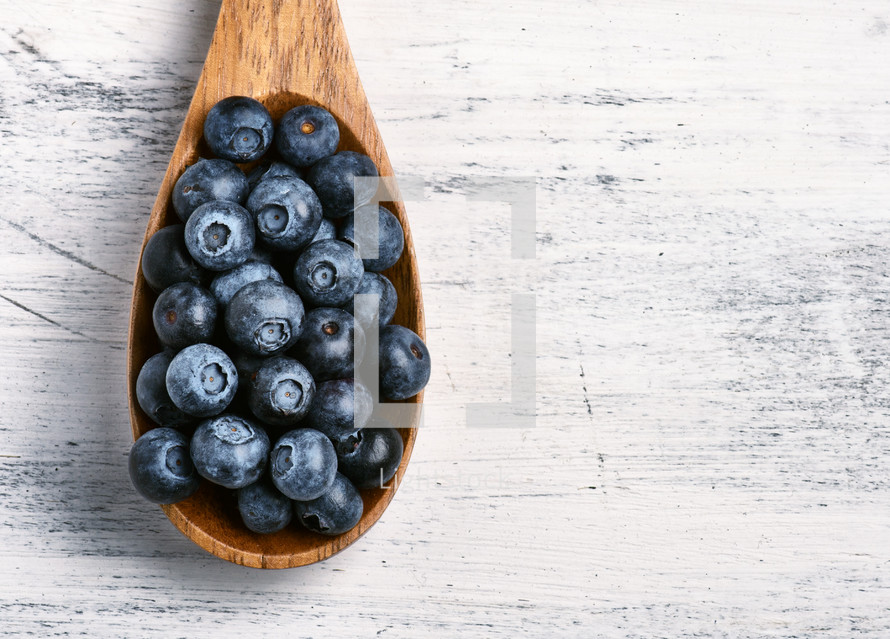 blueberries in a wooden spoon 