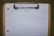 notebook paper on a clipboard 