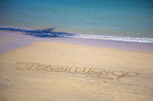 Jesus written in the sands of a beach 