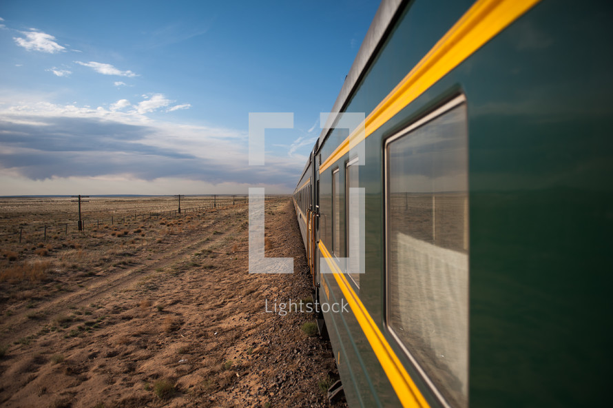 Train traveling through a desert land.