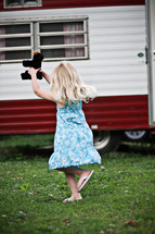 little girl running holding a teddy bear