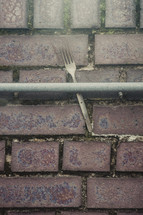 fork in a railing against a wall 