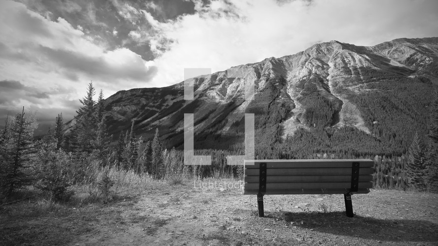 a bench facing a mountain 