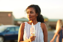 a woman holding an ice cream cone 