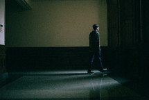 a man walking down a hallway 