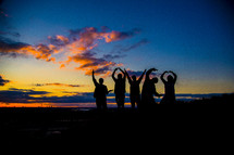men forming silhouettes of the word love 