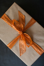 a wrapped gift with an orange bow 