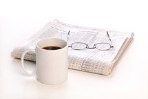 coffee mug, reading glasses, newspaper 
