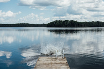 splash at the end of a dock on a lake 