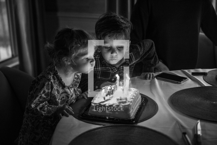 twins blowing out birthday candles 